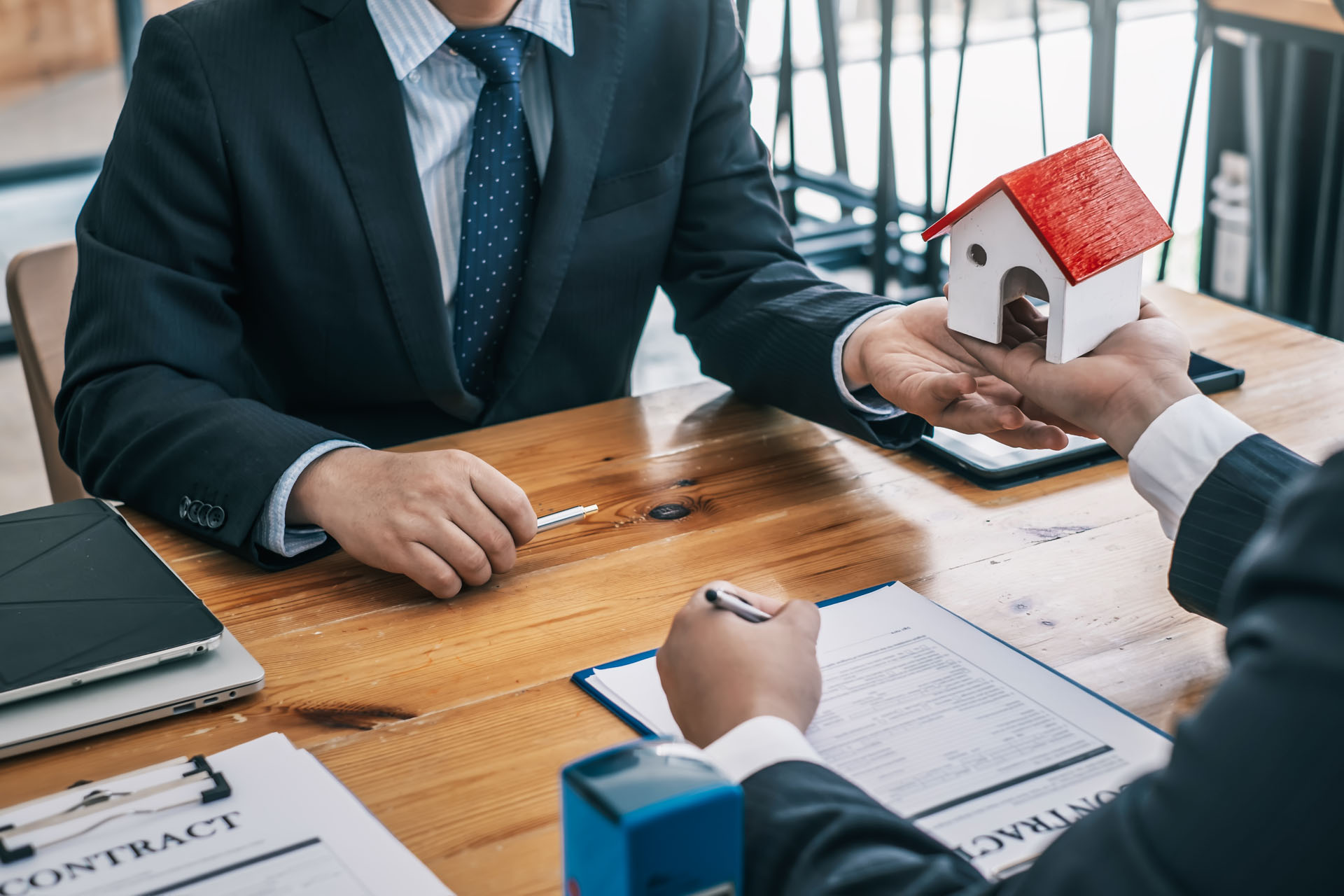 A real estate agent and client sitting at a table